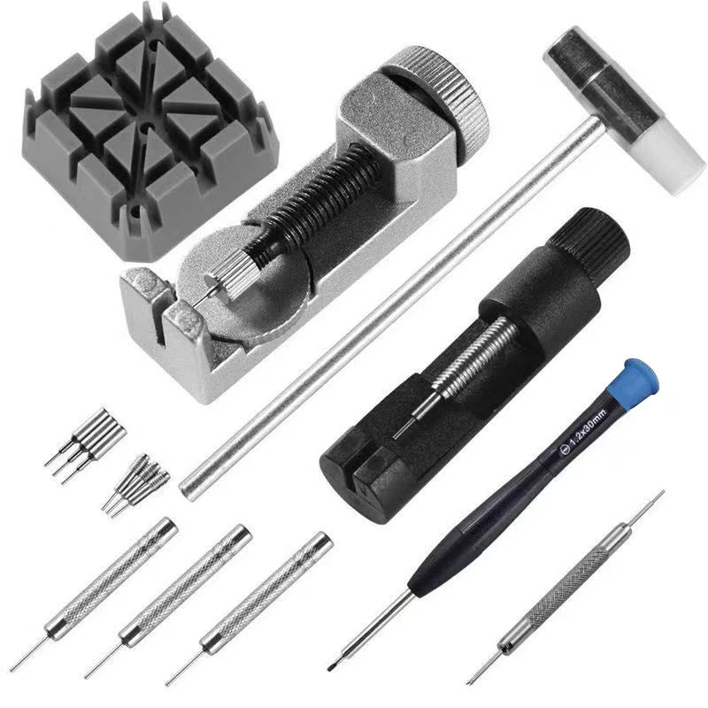 Collection of jewelry-making tools including a clamp, hammer, and various pins on a white background