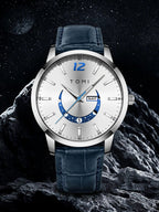 Tomi watch with blue strap on a rocky surface with a dark background