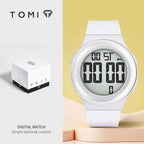 White digital watch with packaging on a light yellow background, featuring the brand 'TOMI'.