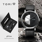 TOMI watch with black leather strap and gift box on a textured surface