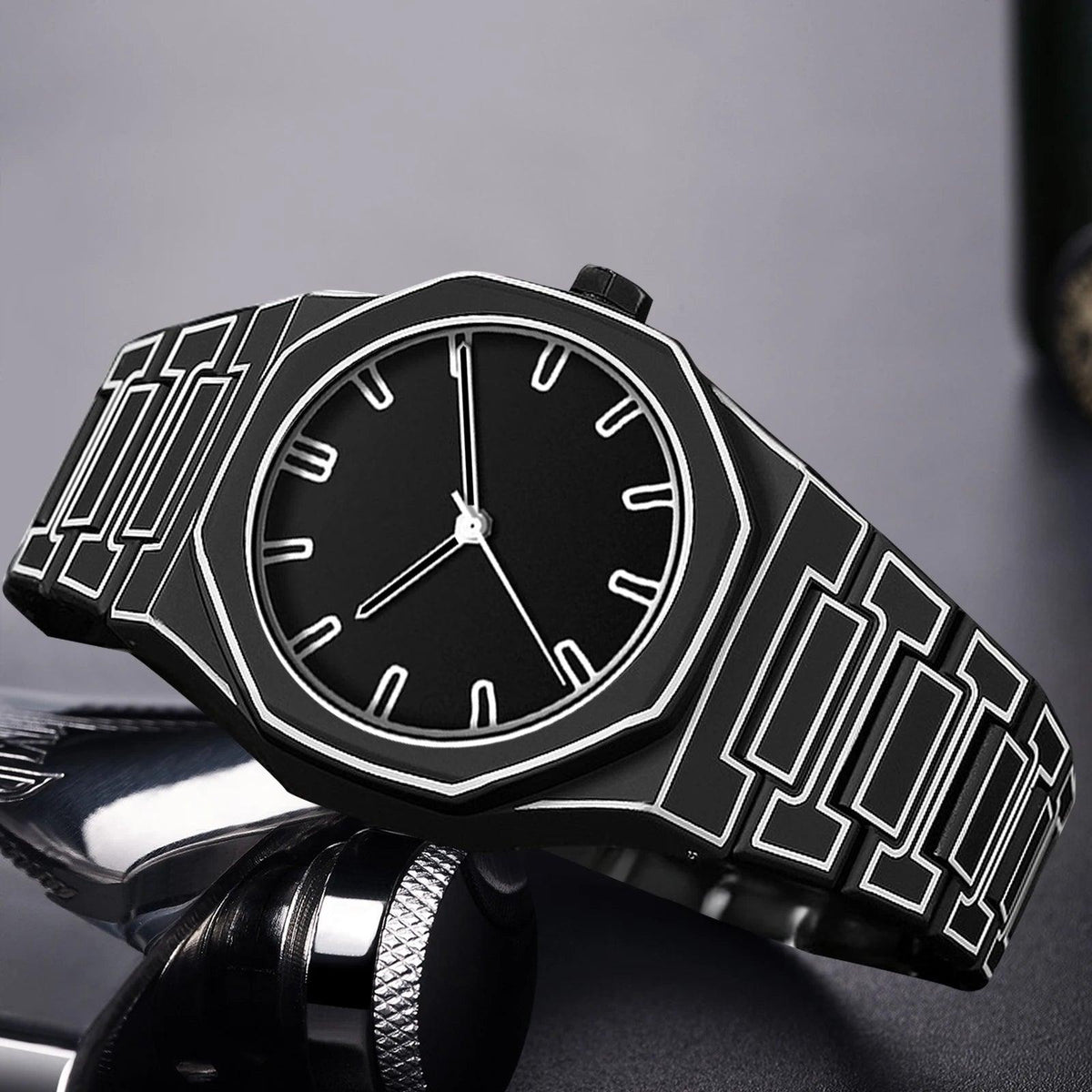 TOMI watch with octagonal case and geometric engraved steel bracelet, minimalist dial with baton hour markers and slim hands