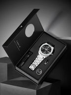 Silver watch with black face in a black box on a gray background