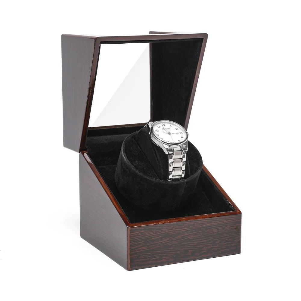 Watch in a wooden box with a clear lid on a white background