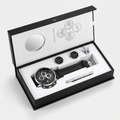 Luxury watch and cufflink set in a branded box on a white background