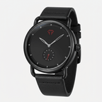 Black wristwatch with a black strap on a light gray background
