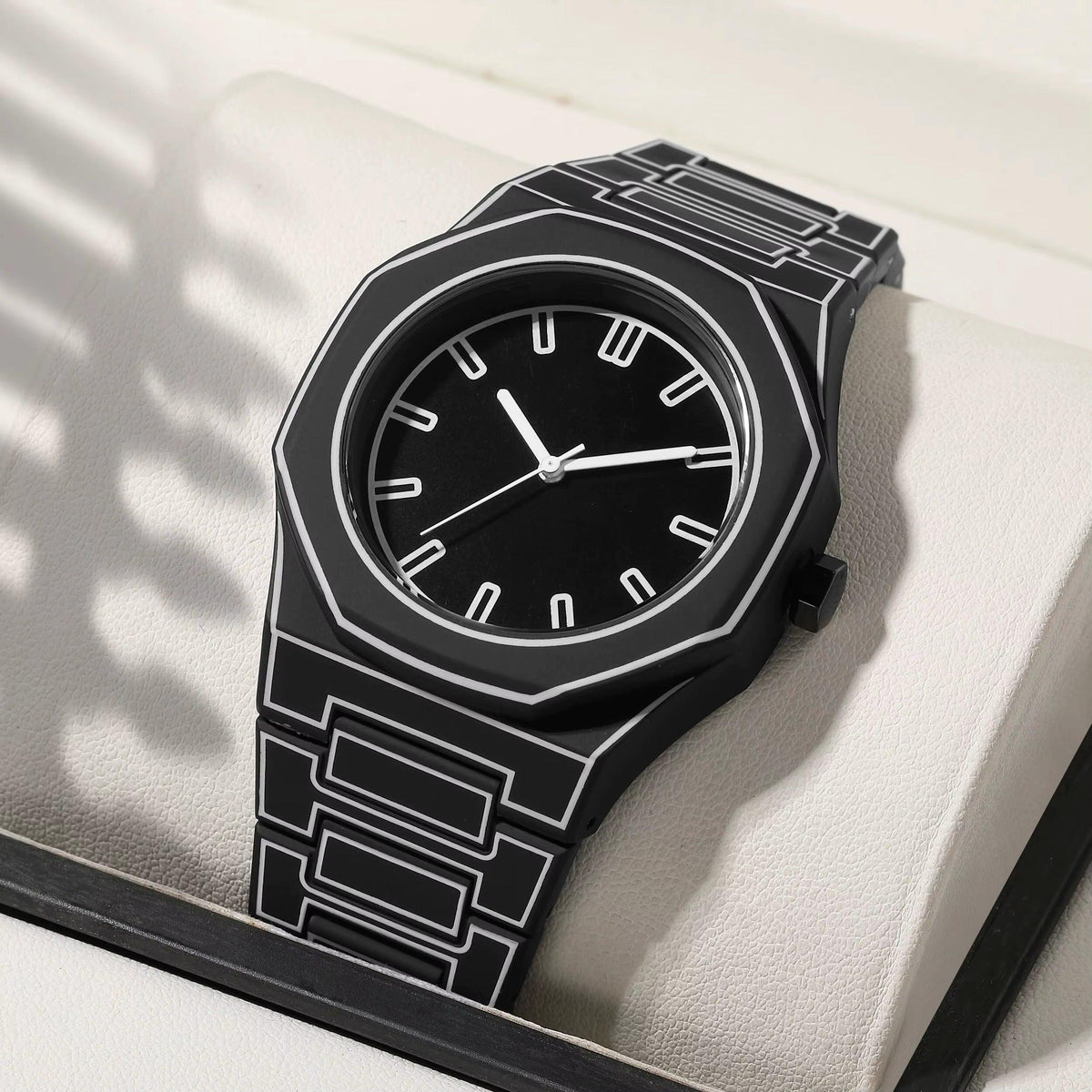 TOMI watch with octagonal case and geometric engraved steel bracelet, minimalist dial with baton hour markers and slim hands