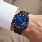 Man wearing TOMI T018 Enigma Splendor watch with blue dial and brown leather strap