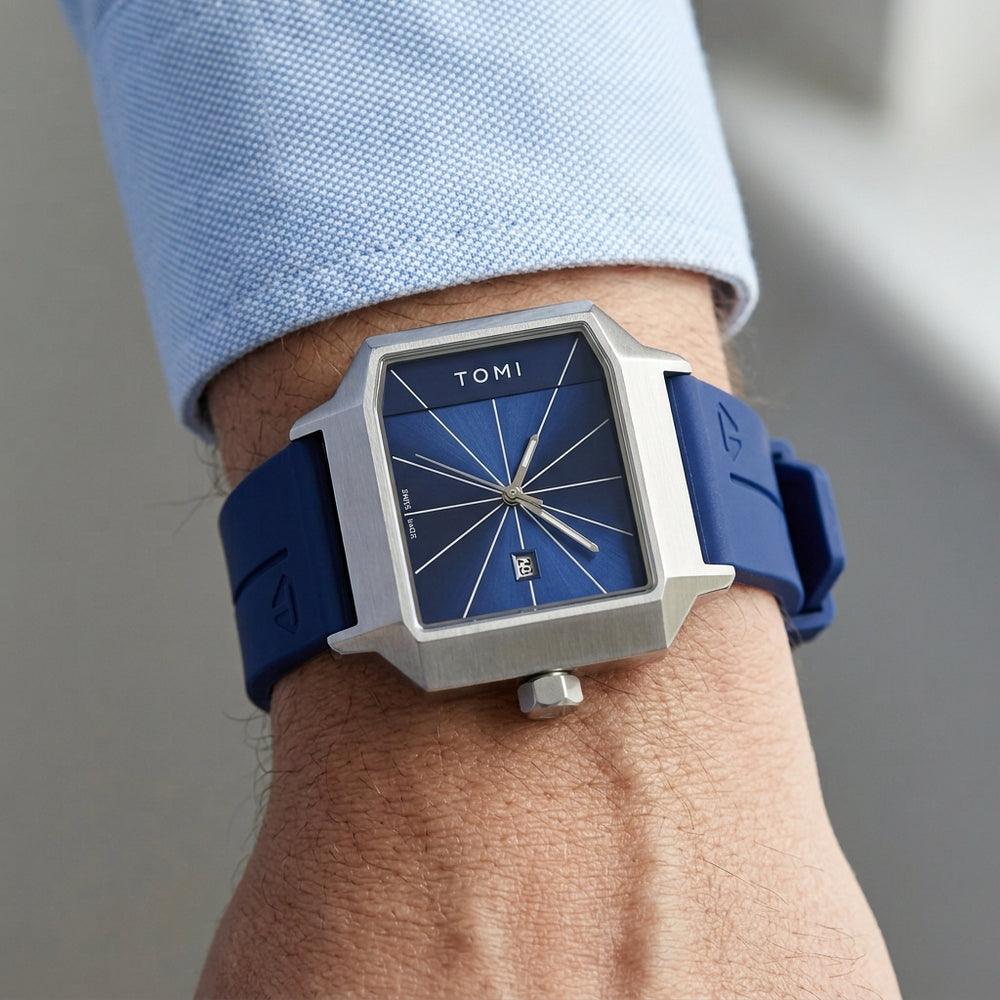 Person wearing a blue watch with silver case and blue strap