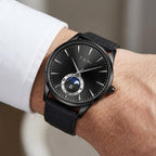 Man wearing TOMI T024 Phantom Radiance watch with black dial and black leather strap