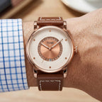 Man wearing TOMI T033 Enduring Heirloom Edition watch with white dial, rose gold case, and brown leather strap