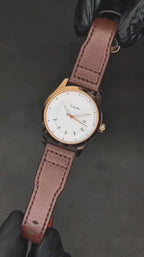 TOMI T099 Perpetual Icon watch with white dial, rose gold case, and black leather strap